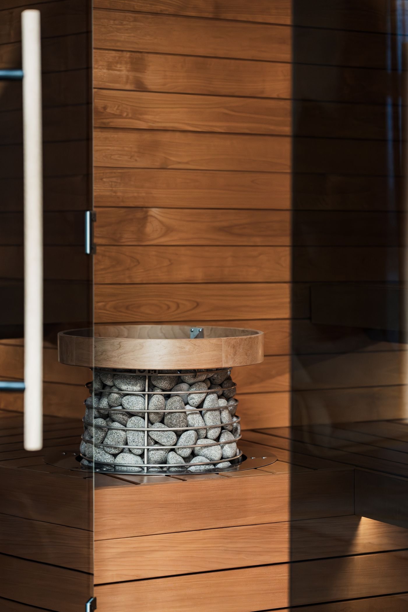 Teak sauna interior with natural stone heater